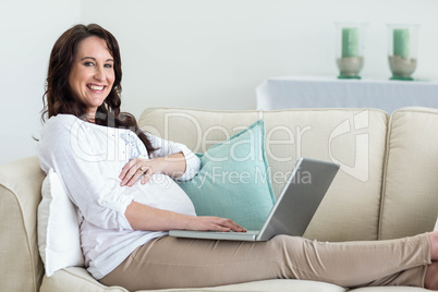 Pregnant woman resting on couch