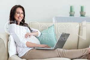 Pregnant woman resting on couch