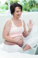 Pregnant woman relaxing with her laptop