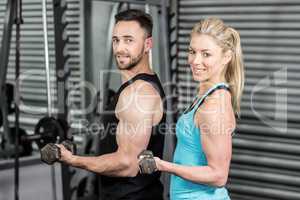 Couple posing with dumbbells