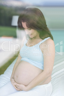 Pregnant woman touching belly