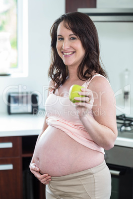 Pregnant woman holding apple