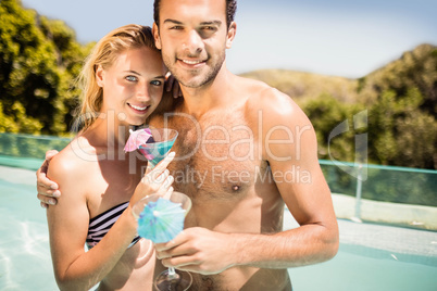 Happy couple holding cocktail