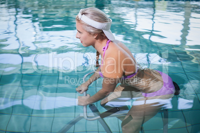 Fit woman doing underwater bike