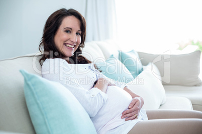 Pregnant woman sitting in the living room