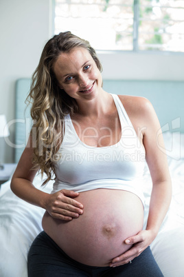 Pregnant woman massaging her belly