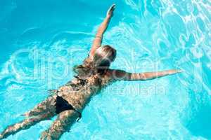 Fit woman swimming in the pool