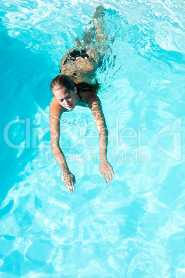 Fit woman swimming in the pool Fit woman swimming in the pool