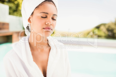 Peaceful brunette with closed eyes wearing white towel