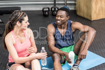 Smiling woman and man talking on sport towel