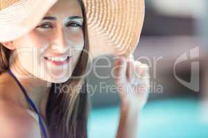 Smiling brunette holding hat