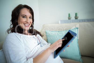 Pregnant woman resting on couch