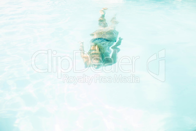 Fit woman swimming under water