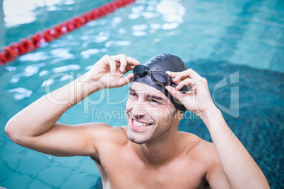 Handsome man wearing swim cap and goggles
