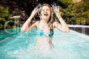 happy blonde splashing