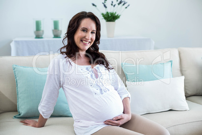 Pregnant woman sitting in the living room