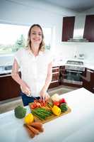 Pregnant woman cutting vegetables