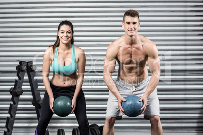 Fit couple doing ball exercise