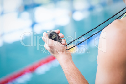 Trainer holding stopwatch