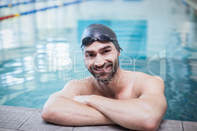 Smiling man wearing swim cap and goggles Smiling man wearing swim cap and goggles