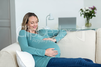 Pregnant woman touching her belly