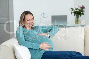 Pregnant woman touching her belly