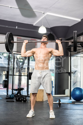 Fit man lifting barbell