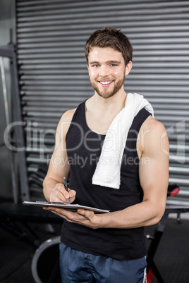 Trainer taking notes at crossfit gym