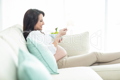 Pregnant woman eating salad