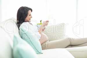 Pregnant woman eating salad