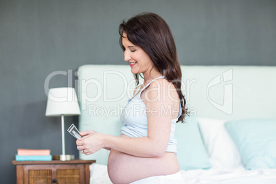 Pregnant woman looking at ultrasound scans