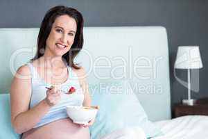 Pregnant woman eating fruit