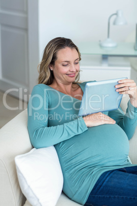 Pregnant woman using a tablet computer