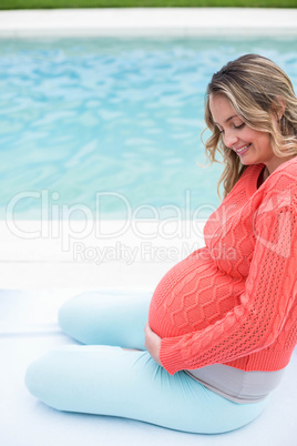 Pregnant woman relaxing outside