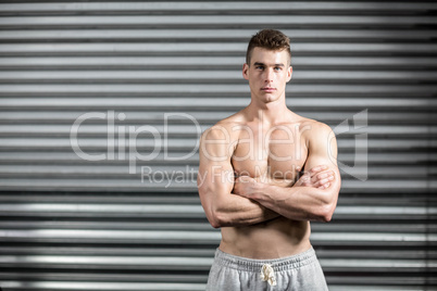 Portrait of fit man with crossed arms