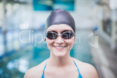 Pretty woman wearing swim cap and swimming goggles