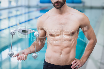 Fit man holding a weighting scale