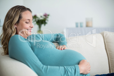 Pregnant woman touching her belly