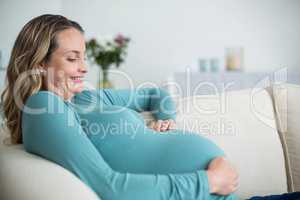 Pregnant woman touching her belly