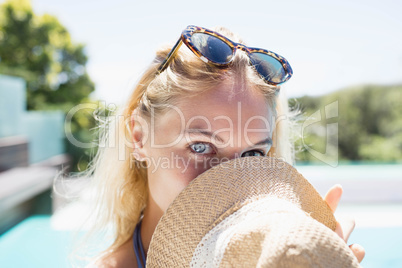 Beautiful blonde hiding face with hat