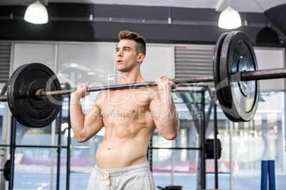 Fit man lifting barbell