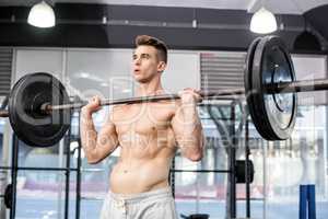 Fit man lifting barbell