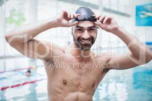 Fit man wearing swim cap and goggles