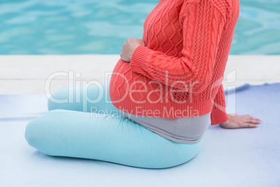 Pregnant woman relaxing outside