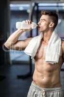 Fit man drinking water
