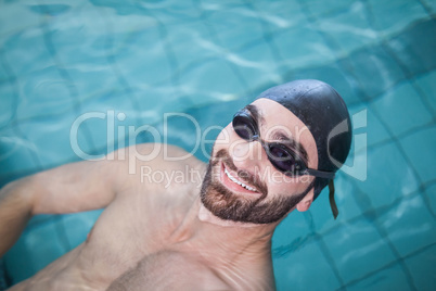 Fit man swimming on the back