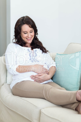 Pregnant woman resting on couch