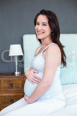 Pregnant woman touching her belly