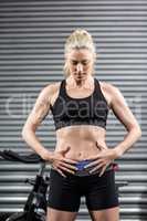 Fit woman with hands on abs
