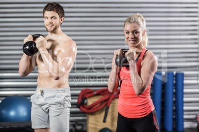 Couple lifting dumbbells together